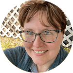 Woman with short hair and blue rimmed glasses