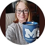 Headshot of a smiling woman holding a coffee cup