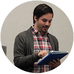 A man reads from some text he holds in his hands