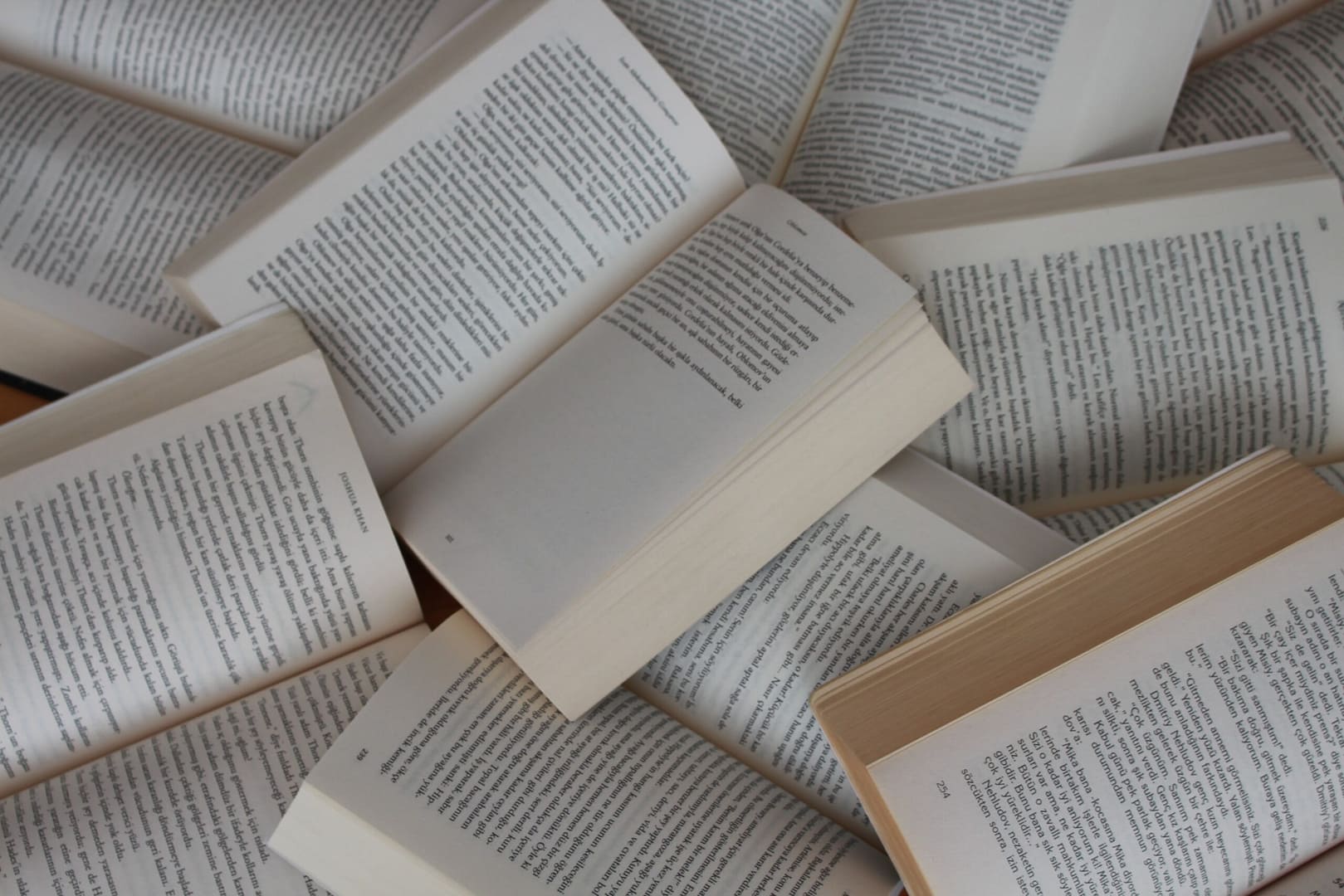a pile of open books, artfully arranged