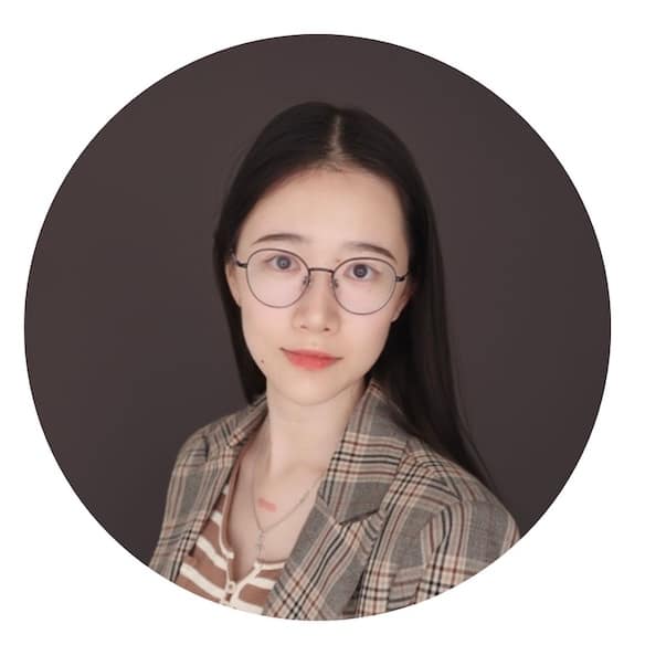 A circular crop of a woman wearing glasses against a grey background