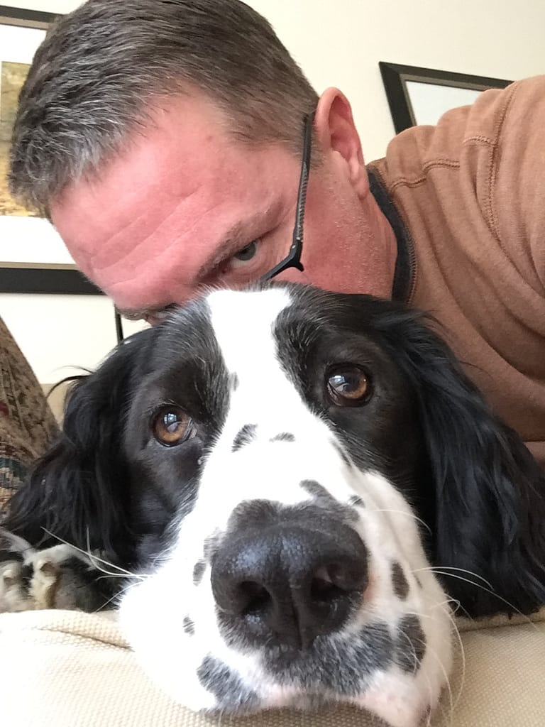Troy wearing glasses and a dog