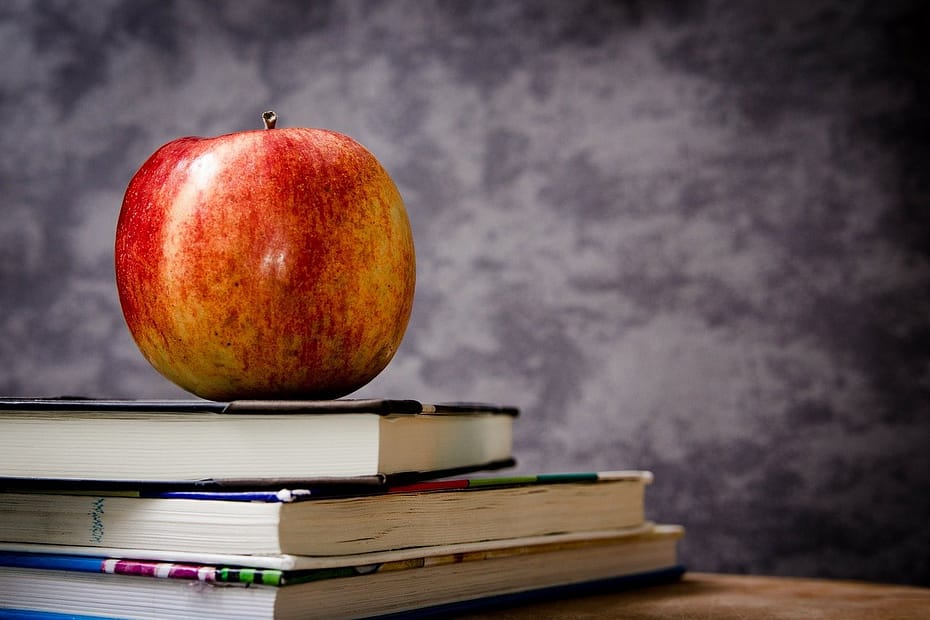 Apple sitting on top of books