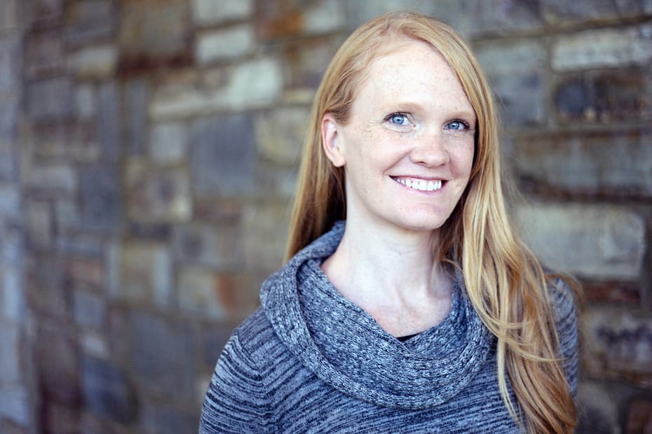 Dr. Amy Collier, a white woman, smiling against a brick background