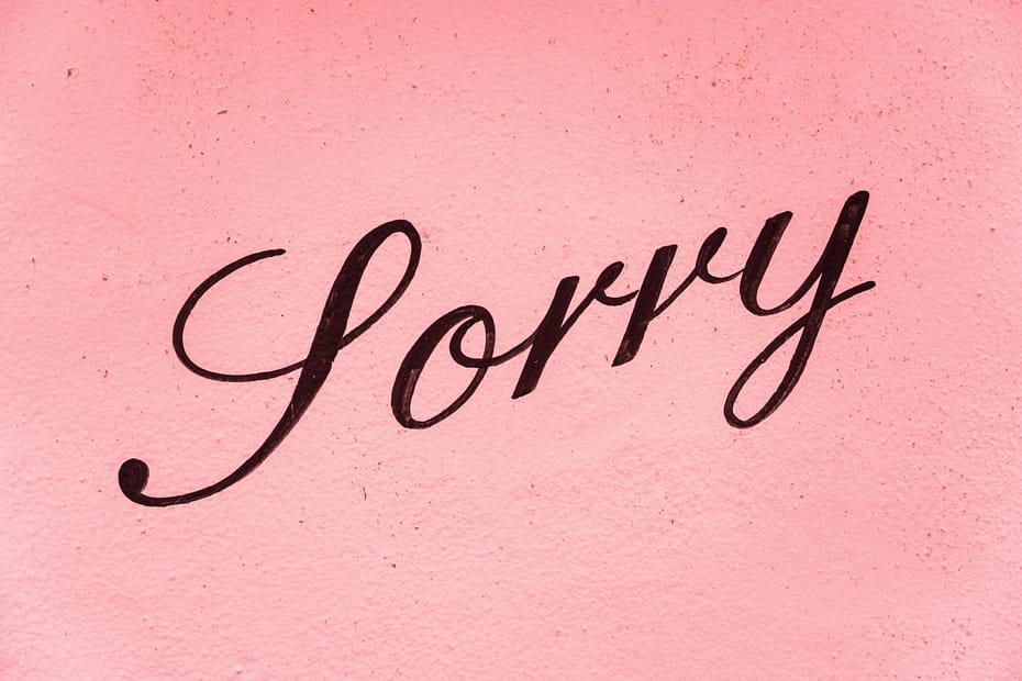 the word sorry on a pink background